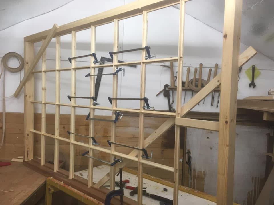 Large window with glazing bars clamped up in the workshop