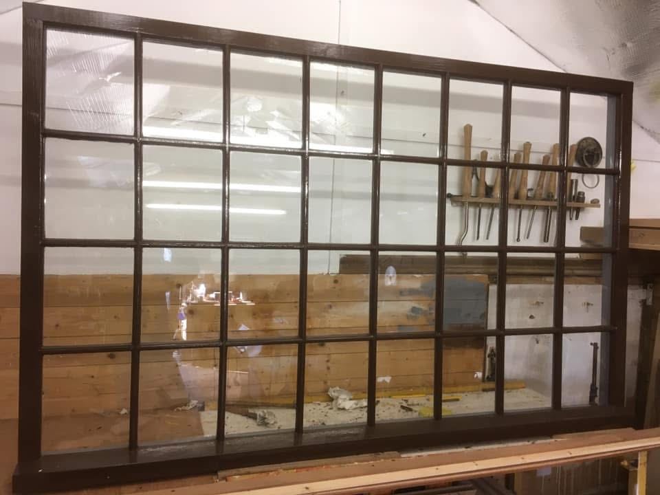 The large multi-pane window finished in dark brown
