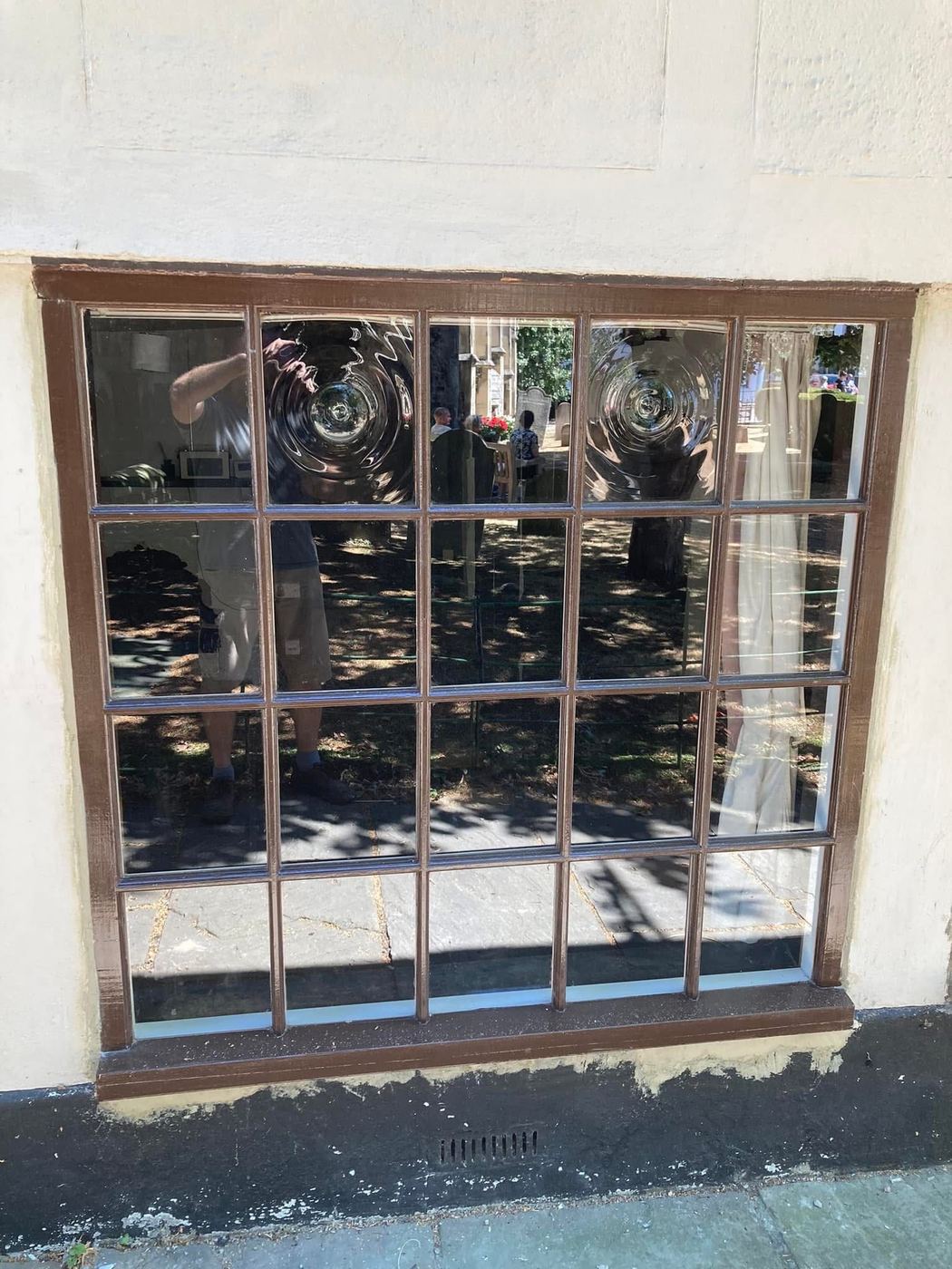 The finished window fitted and painted dark brown